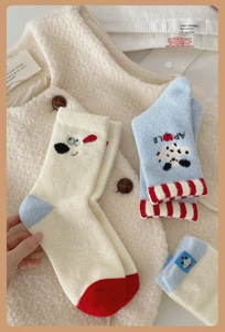 Close-up of thick winter socks featuring soft knit texture and cute cartoon embroidery