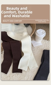 Thick ribbed cashmere socks in brown, beige, and black colors on a cozy white rug