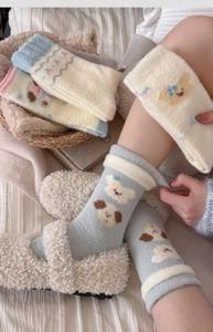 Detailed texture of thick winter plush socks with cute puppy and bear jacquard patterns