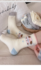 Detailed view of thick thermal coral fleece socks with cute cartoon dog pattern and soft texture