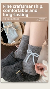 Close-up of thick knit wool socks featuring 3D bow accents and colorful dot patterns