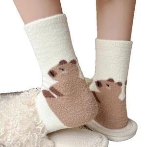 Thick warm mid-tube fuzzy socks featuring cute brown capybara embroidery on cream fabric