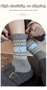 Detail of grey wool socks with blue bow patterns and elastic rolled cuffs for winter