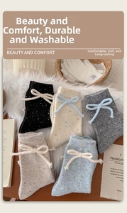 Detailed knit texture of wool crew socks featuring colorful flecks and cute bow accents