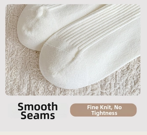 Detailed macro view of seamless toe stitching and soft rib knit texture on white cashmere socks