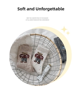 Detailed knit texture of wool-blend socks with cute bear embroidery in a cozy basket