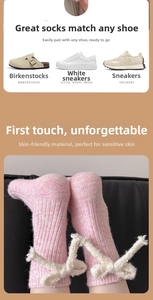 Detailed knit texture of pink wool socks with cute plush white bows for winter warmth