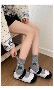 Detail of grey wool socks with cute bear pattern worn with Mary Jane shoes