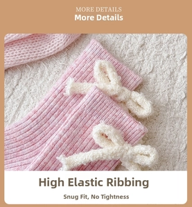 Detail of pink wool sock featuring a fuzzy white plush bow and ribbed knit texture