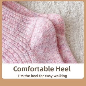 Macro detail of the vertical ribbed knit heel on pink and white wool blend socks