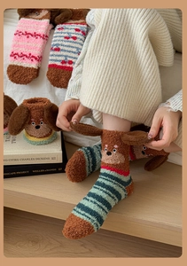 Close-up of cozy coral fleece socks with 3D cartoon puppy ears in soft winter colors