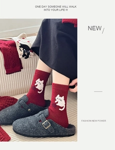 Detailed view of red wool socks with cute white cat knit pattern and stylish crew length
