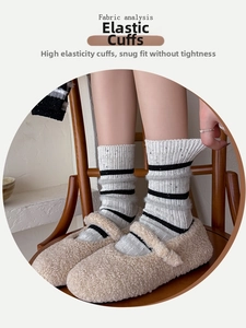 Detail of elastic striped wool socks with grey fuzzy trim and ribbed texture