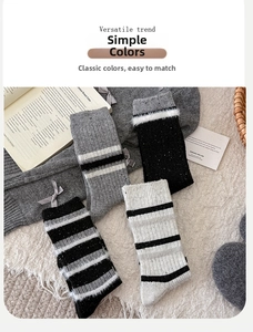 Close-up of thick striped wool socks in black, white and grey with warm knit texture