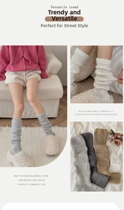 Detailed knit texture of thick wool leg warmers in grey, cream and coffee colors