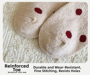 Close-up of reinforced sock toe with red polka dots and fine stitching details