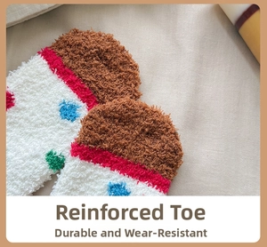 Detail view of reinforced brown toe on coral fleece socks with colorful polka dots