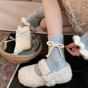 Thick wool socks with cute bow ties and colorful speckled dots for winter warmth