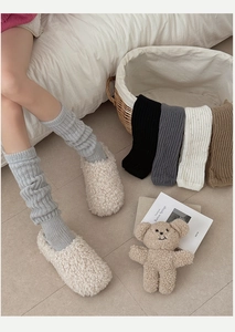 Detail shot of cozy wool blend leg warmers in various colors for winter fashion