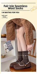 Detail of wool Fair Isle socks featuring heart and snowflake patterns in warm brown tones