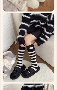 Detail of coral fleece striped calf socks featuring a cute bear head logo patch