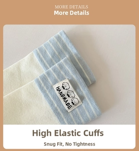 Detail of high-elasticity ribbed cuff on beige socks with handmade puppy label