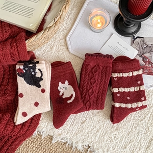 Set of four cozy wool socks with cute cat patterns and knit textures in red and beige