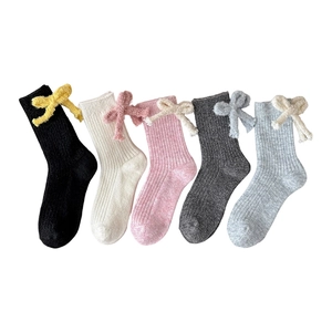 Five pairs of wool mid-tube socks with plush bows in black, white, pink, and grey