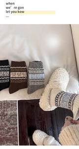 Detail of wool knit socks with bow pattern and retro jacquard weave in three colors