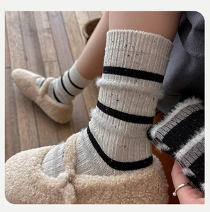 Close-up of wool blend thermal crew socks with black stripes and speckled knit texture