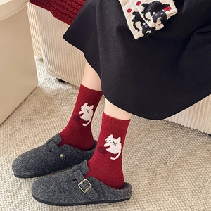 Cute red wool socks with cat pattern styled with gray mule shoes for winter