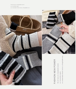 Detail of wool blend striped socks showing soft feather yarn texture and warm winter style