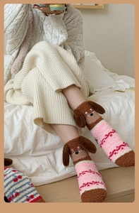 Detail of coral fleece winter socks with 3D cartoon dog and pink stripe pattern