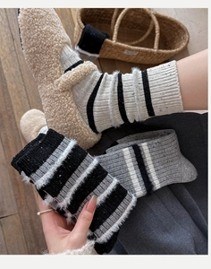 Close-up of thick striped wool socks with soft feather yarn texture for winter warmth