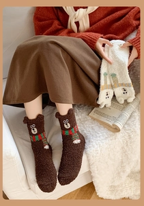 Detail of coral fleece socks with 3D bear ears and embroidered scarves in brown and white