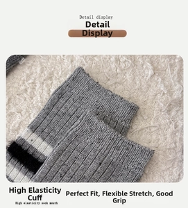 Macro detail of high elasticity gray wool sock cuff with textured rib knit design