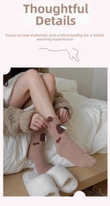Close-up of warm brown coral fleece socks with cute 3D ears and cartoon embroidery detail