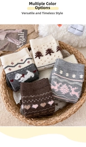 Close-up of four pairs of thick wool socks with winter dog and reindeer patterns in a basket