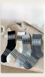 Detail of four pairs of vintage Fair Isle knit socks in black, white, and grey tones