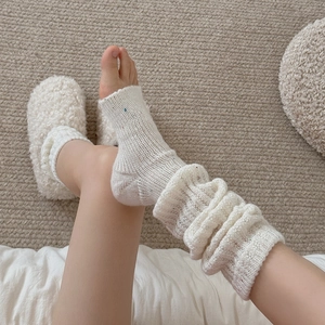 Thick off-white wool knit leg warmers with colorful specks for winter warmth