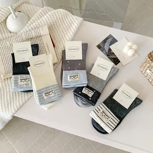 Set of 5 pairs of cute cartoon crew socks in grey and white tones with handmade labels