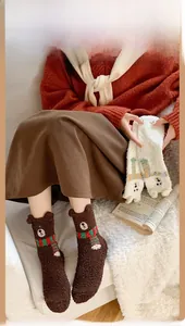 Detail of soft coral fleece socks with 3D bear head and striped scarf embroidery