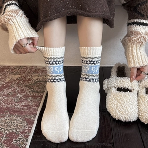 Thick wool Fair Isle crew socks with blue bow patterns and Nordic snowflake designs