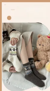 Detail of warm Fair Isle bear pattern socks with thick knit texture for winter