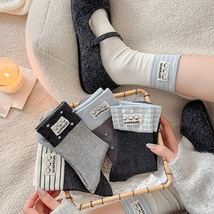 Set of cute crew socks with cartoon dog patches and handmade knit texture in gray tones
