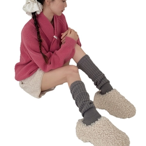 Women's warm wool knit leg warmers in dark grey paired with stylish winter loungewear
