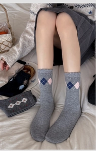 Gros plan de chaussettes en laine à motif losanges avec bords ondulés et maille douce