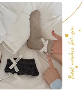 Gros plan de chaussettes en coton côtelé avec nœuds en dentelle et revers élastiques