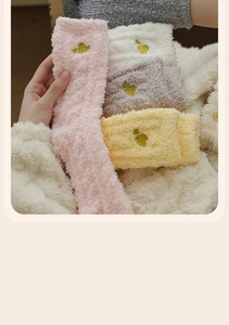 Detail of soft coral fleece socks with golden heart embroidery in various colors