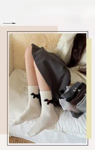 Gros plan de chaussettes en laine avec broderie de chiot mignon dans un décor de maison
